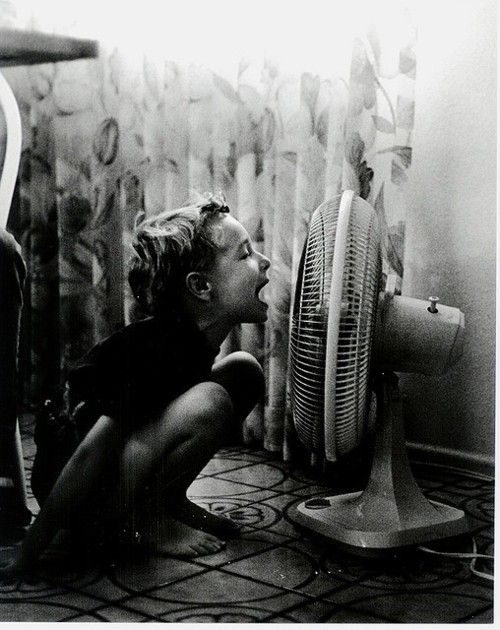 Girl talking into fan